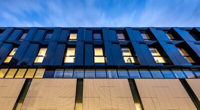 Circle Rehabilitation Hospital facade at night. Hospital design by Bryden Wood