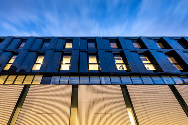 Circle Rehabilitation Hospital facade at night. Hospital design by Bryden Wood